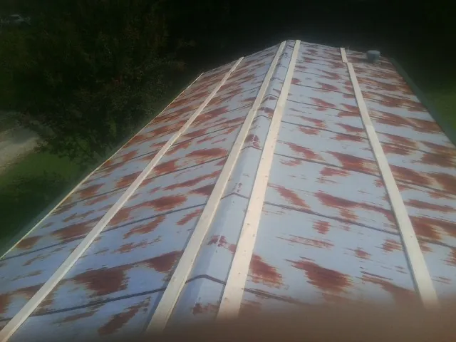 Rusted metal roof panels with new wood purlins before replacement — Storm Damage Roof Repair in Tabernash by Roofing Brothers